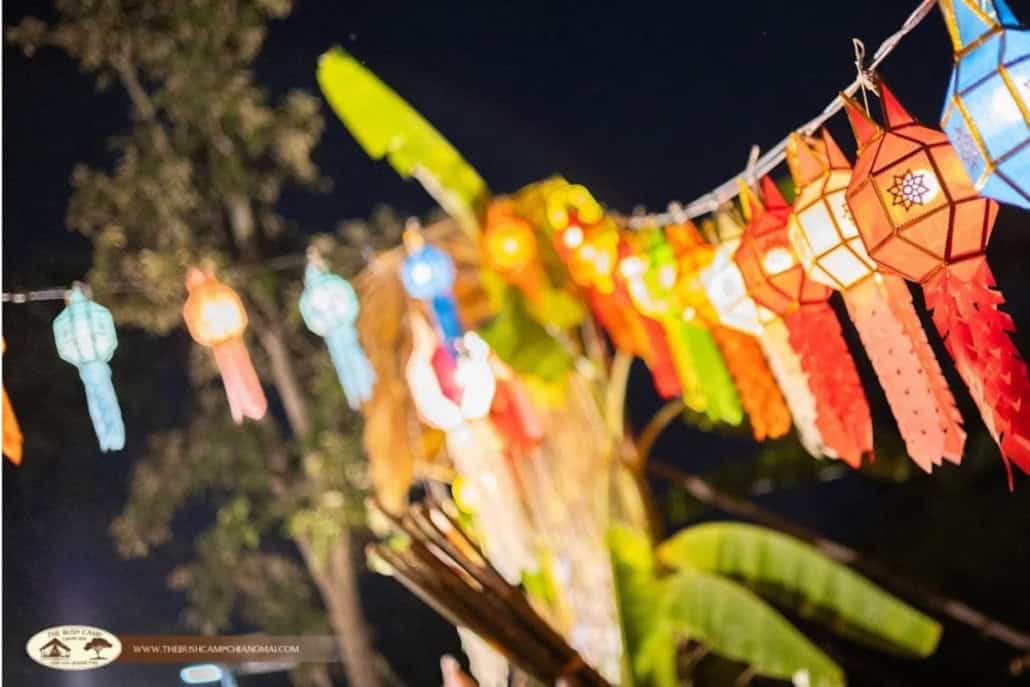 Colourful Lanna paper lanterns hanging on a string at night during the Loy Krathong celebration